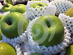 Pile of green apple in the white Fruit Packaging Foam Net.
